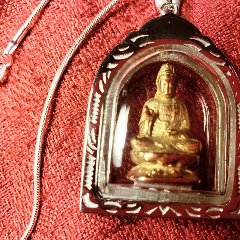 Temple of Quan Yin clear glass sanctuary necklace. She sits on a gold th…